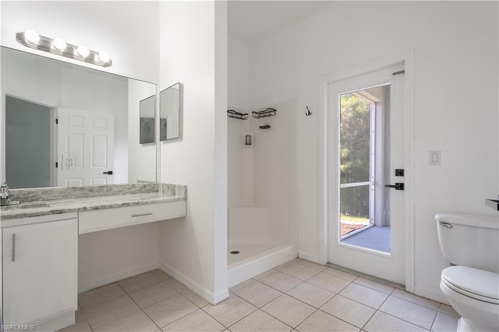 Bathroom vanity featuring a light-toned stone countertop and integrated sink, possible pool bath in future!