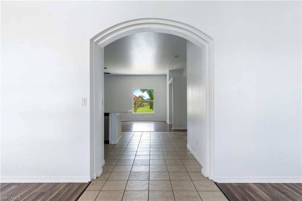 Archway entry to interior space featuring tile flooring