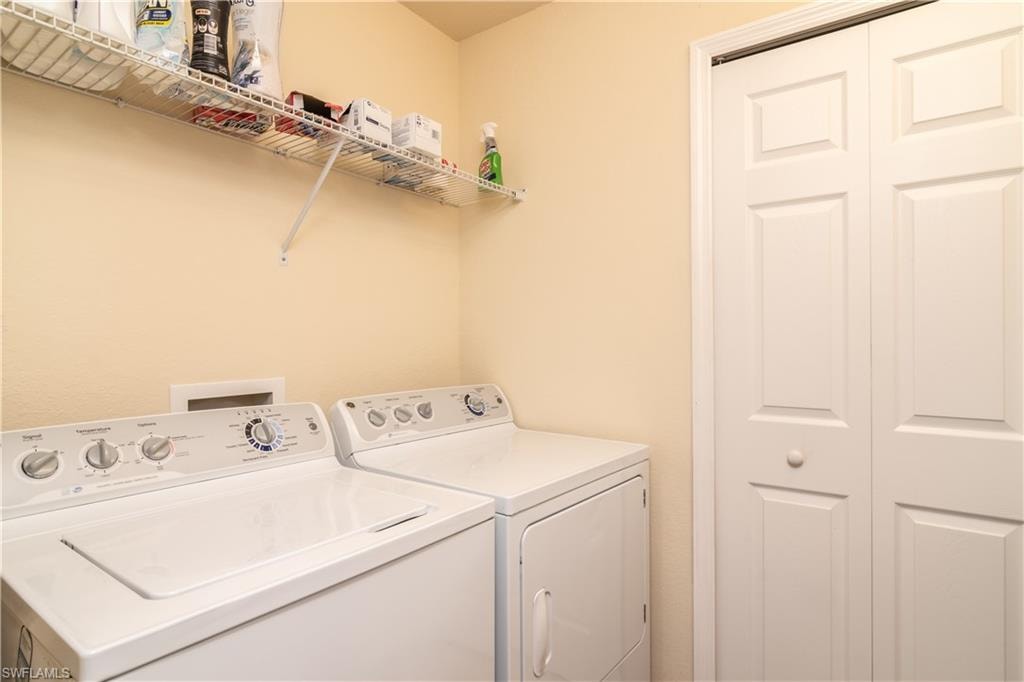 Dedicated laundry area featuring a top-load washer and front-load dryer