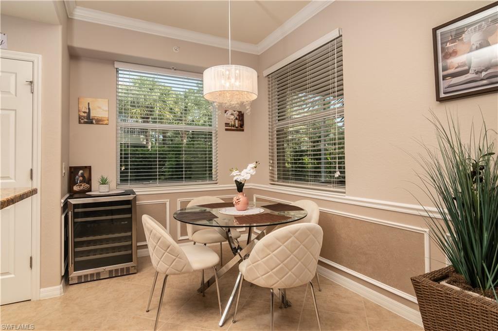 Dining area featuring a contemporary chandelier, crown molding, and wainscoting details