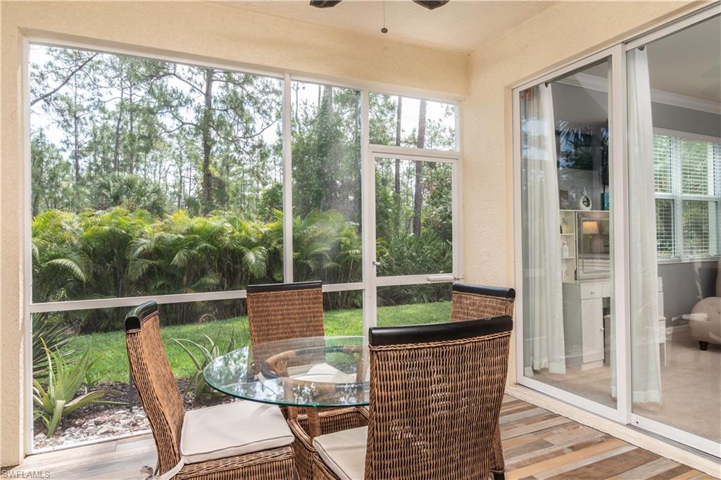 Screened-in patio featuring wood-finish tile flooring and direct access to the interior via sliding glass doors