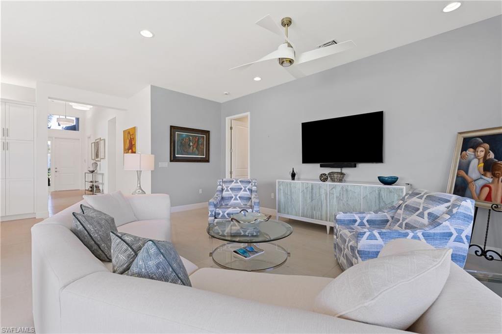 Open area great room with custom paint, ceiling fan.