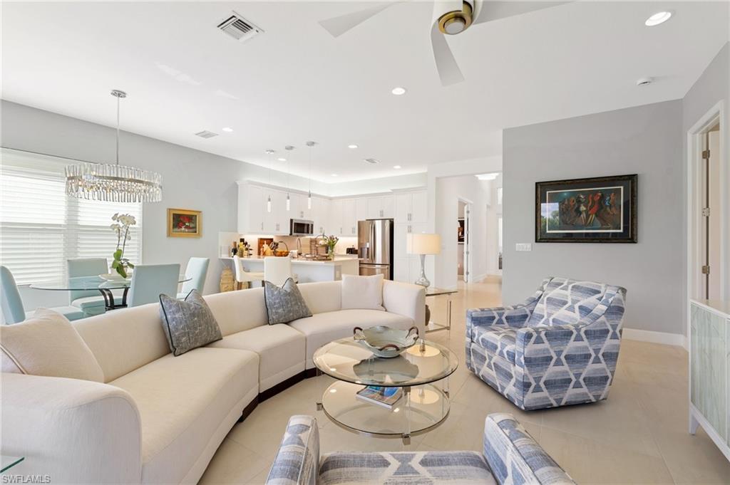 Open concept layout featuring seamless flow between the living room, dining area, and kitchen, perfect for modern entertaining and bright, airy living.