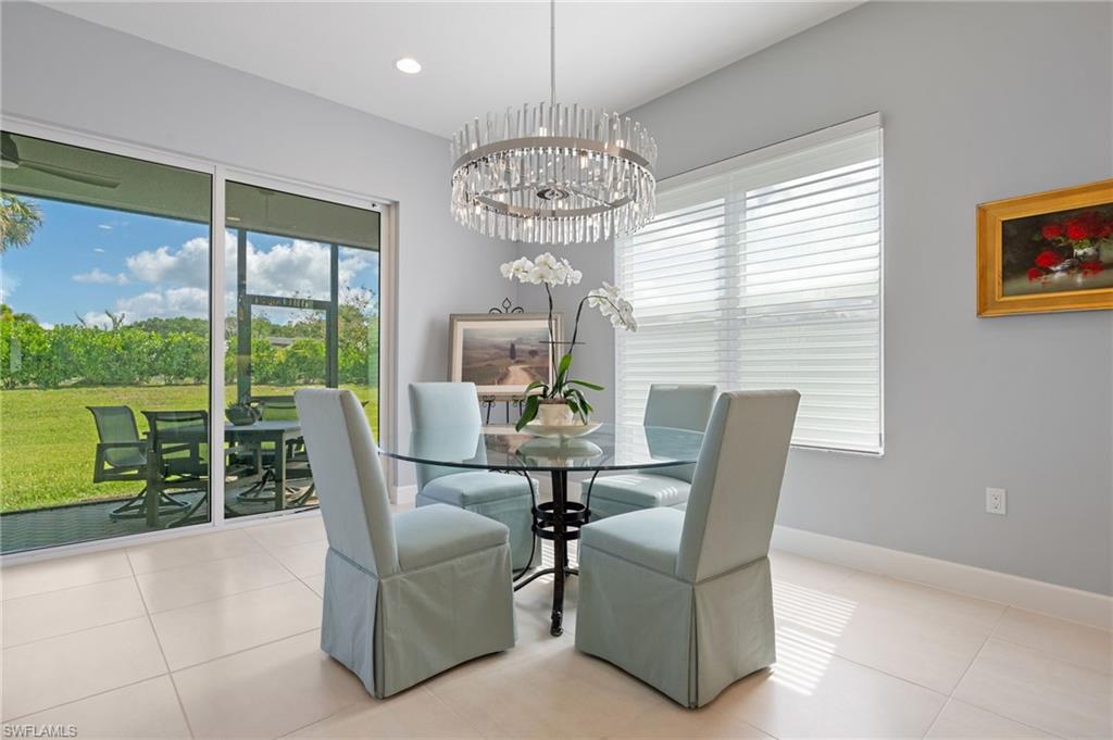 Elegant dining area with chandelier and custom window treatments.