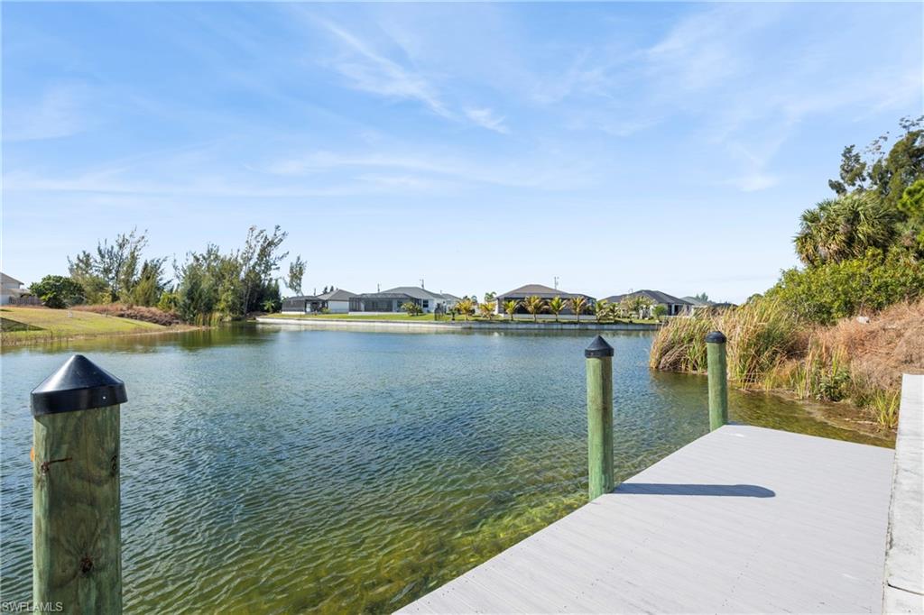 Dock with a water view and a residential view