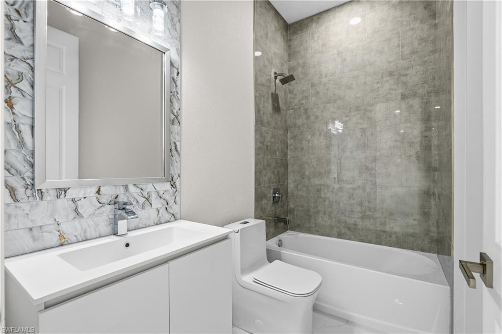 Bathroom with vanity and shower / tub combination