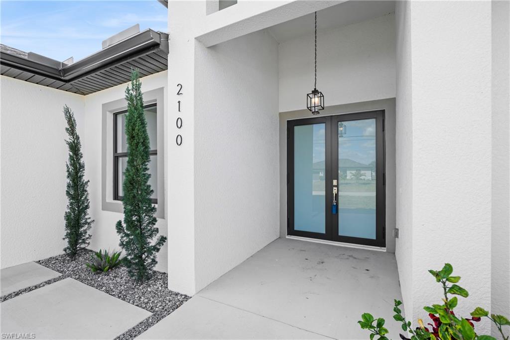 Doorway to property with french doors and stucco siding