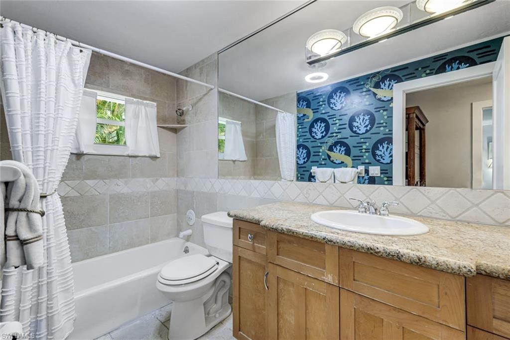 Guest bathroom features a shower/tub combo.