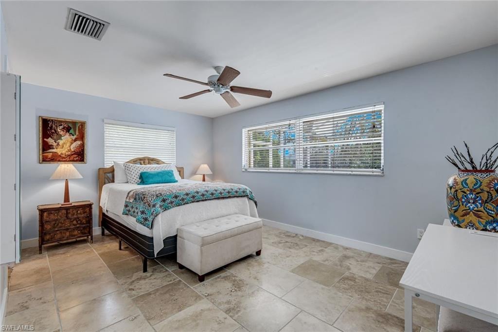 Primary suite offers pool and canal views.