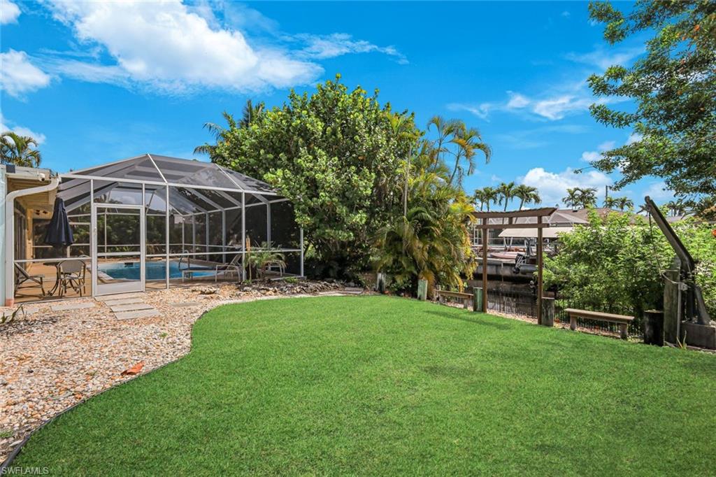 HUGE yard featuring an outdoor shower AND a boat davits.