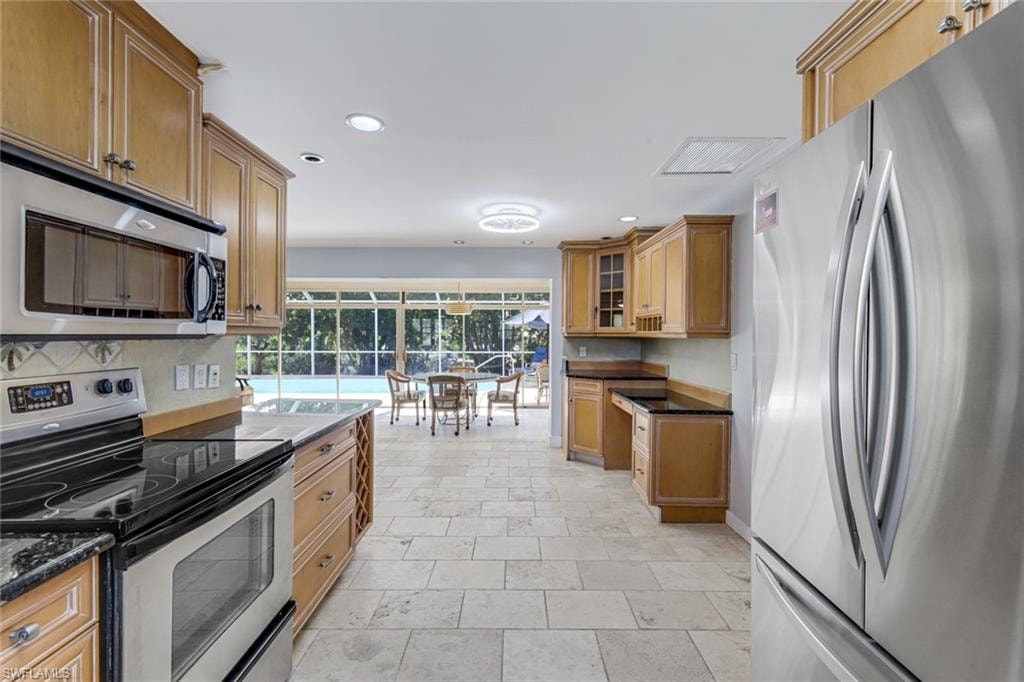 Kitchen features stainless appliances.