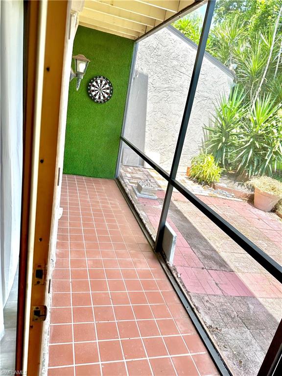 Screened-in patio with terra cotta tile flooring