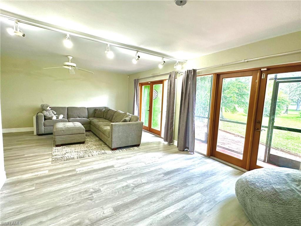 Interior space featuring wood-finish flooring, a ceiling fan, and track lighting