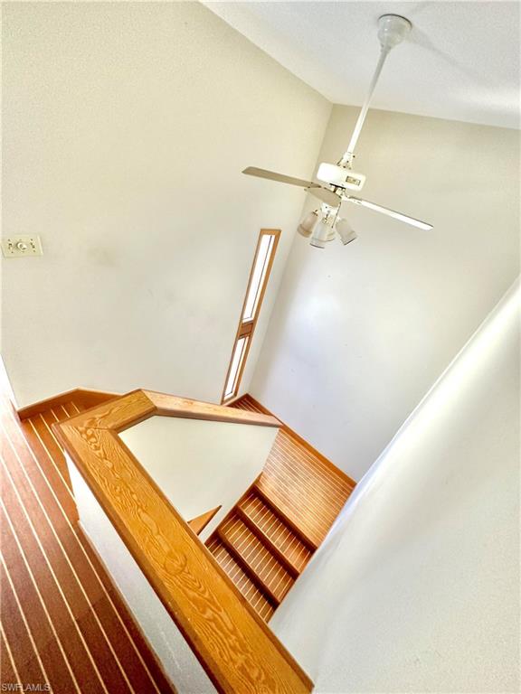 Hardwood stairs with light wood railings and white risers