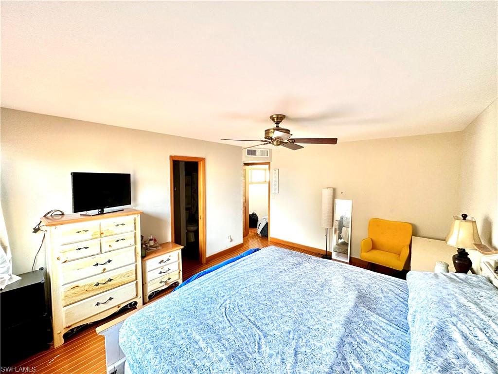 Room featuring wood-finish flooring and a ceiling fan