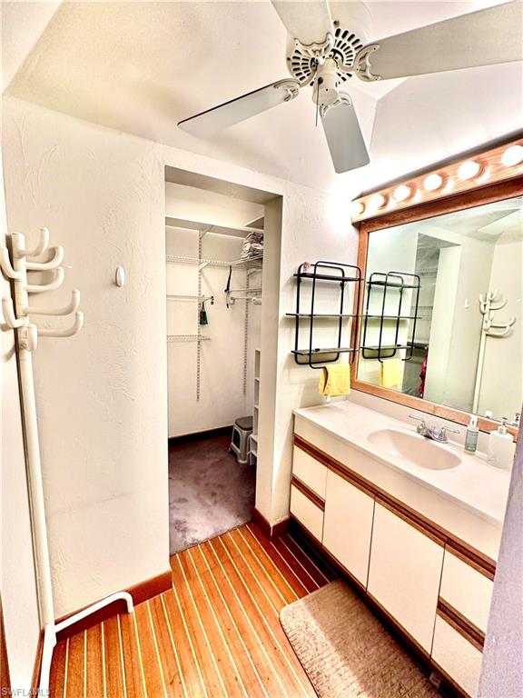 Dual vanity with integrated sinks and a large framed mirror with Hollywood lighting