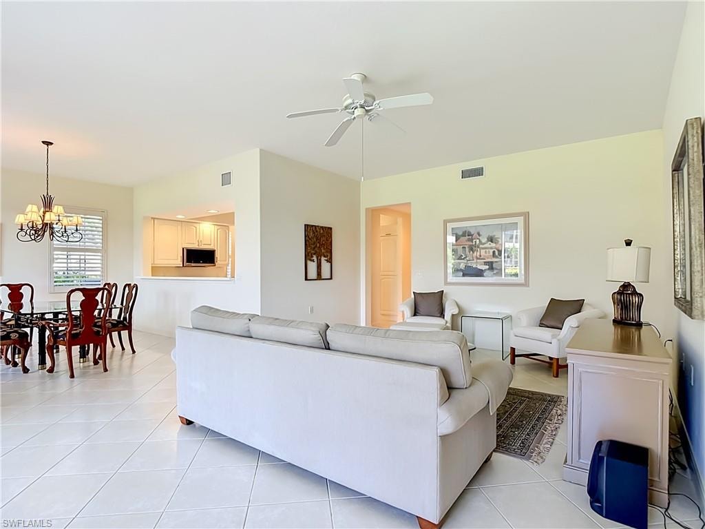 Open concept living area with vaulted ceilings, recessed lighting, and tile flooring throughout