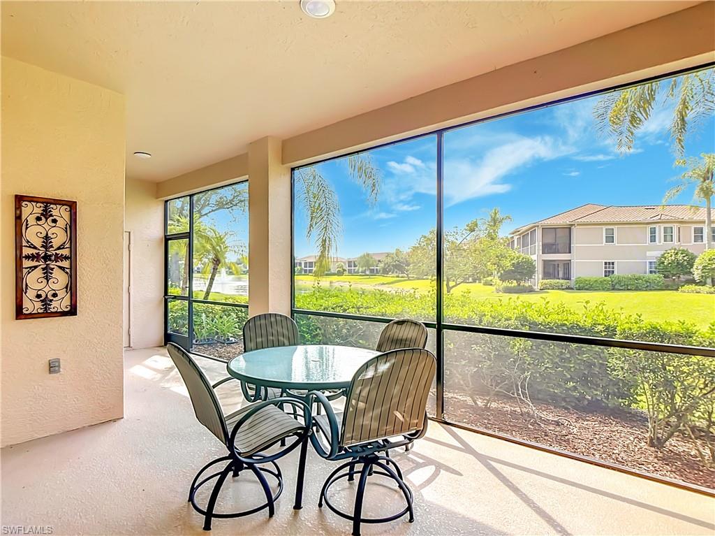 Expansive screened lanai with textured flooring, offering direct access to the outdoors