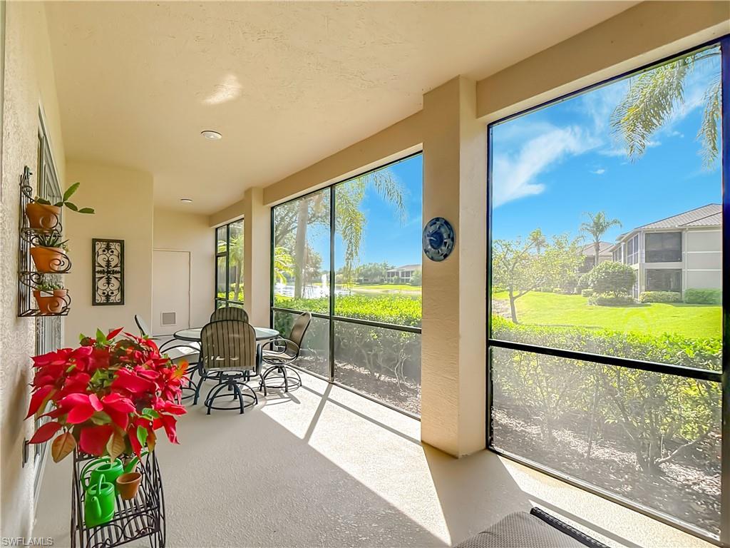 Screened lanai featuring a solid ceiling and textured flooring