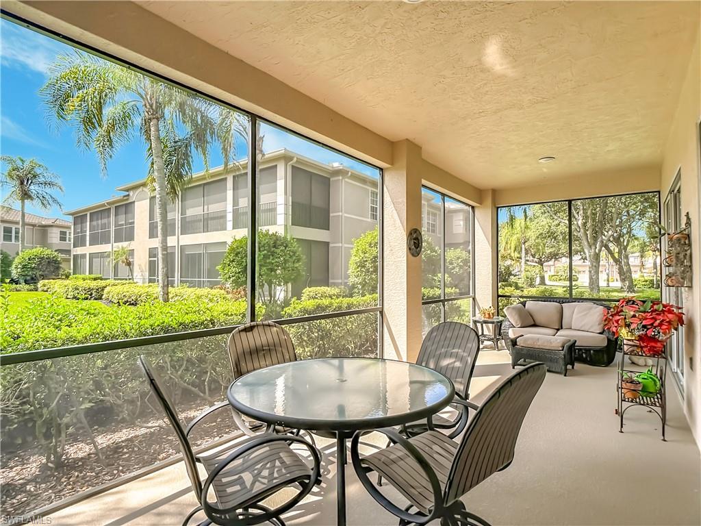 Screened outdoor living space with textured ceiling and a neutral-toned concrete floor