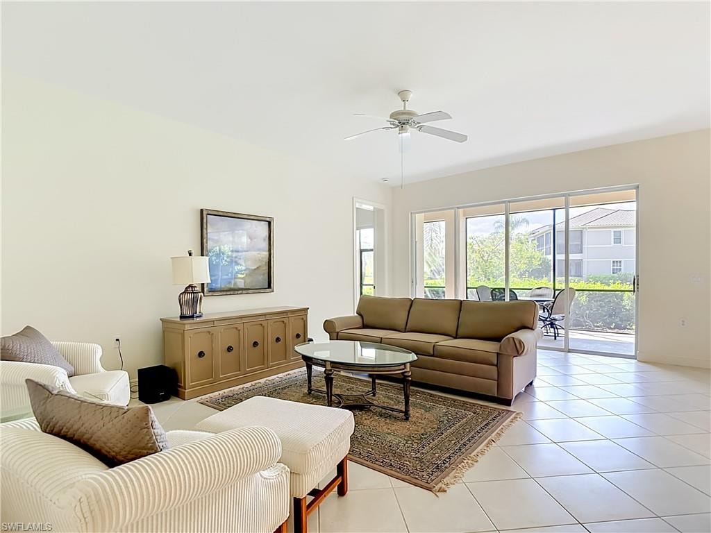 Spacious living area featuring tiled flooring and a ceiling fan