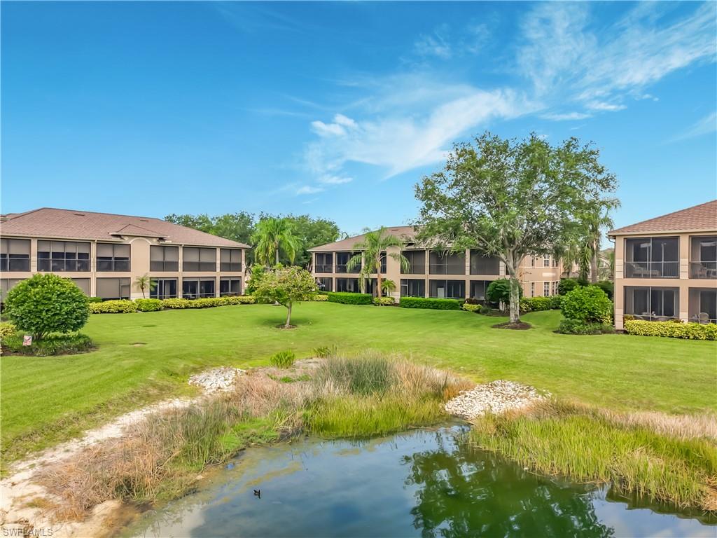 Waterfront setting featuring mature trees and expansive green space