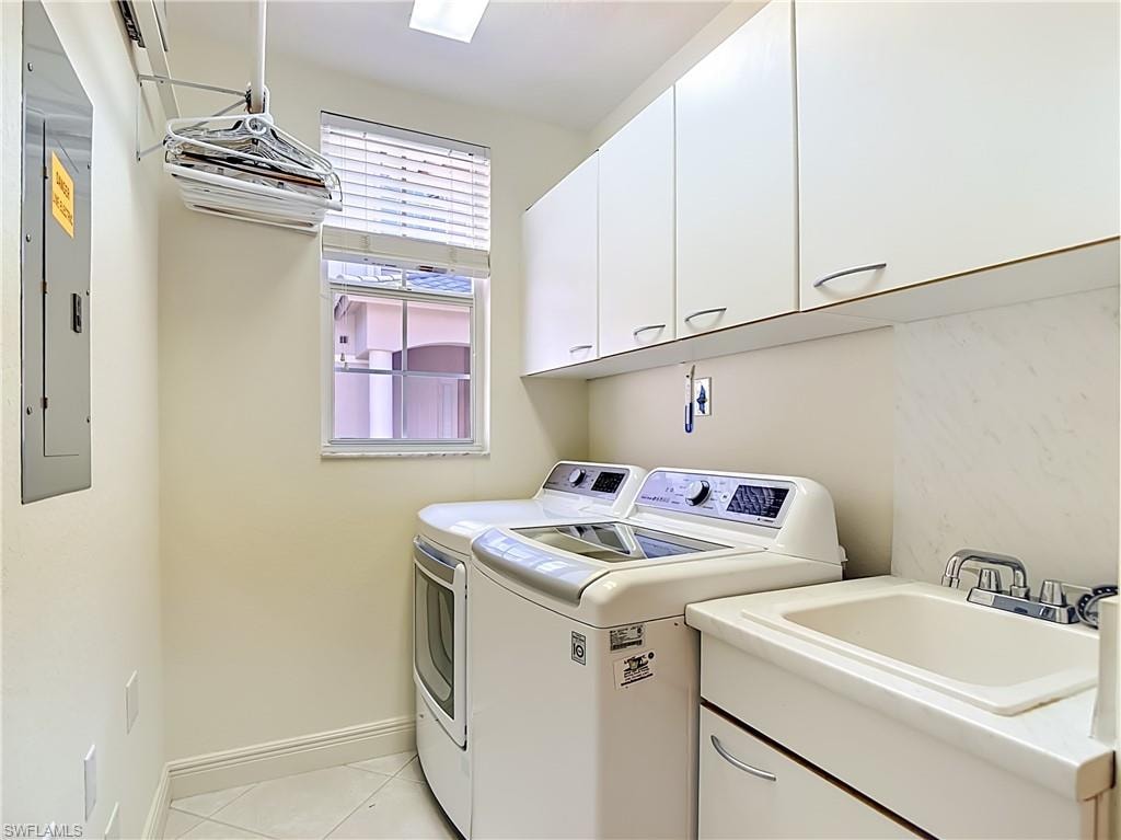 Laundry room featuring a utility sink, white cabinetry, and tiled flooring