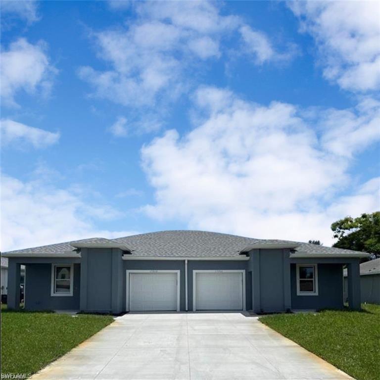 Contemporary duplex exterior featuring a neutral gray facade, a gray shingle roof, two white garage doors, a concrete driveway, and a manicured green lawn