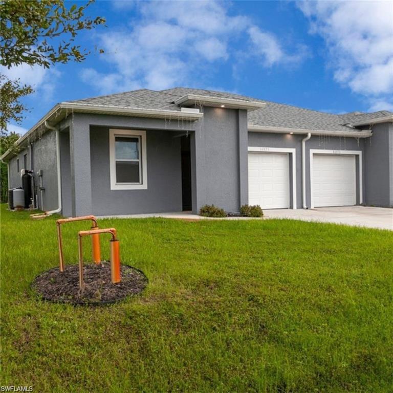 Modern single-story residence with a gray stucco exterior and white trim