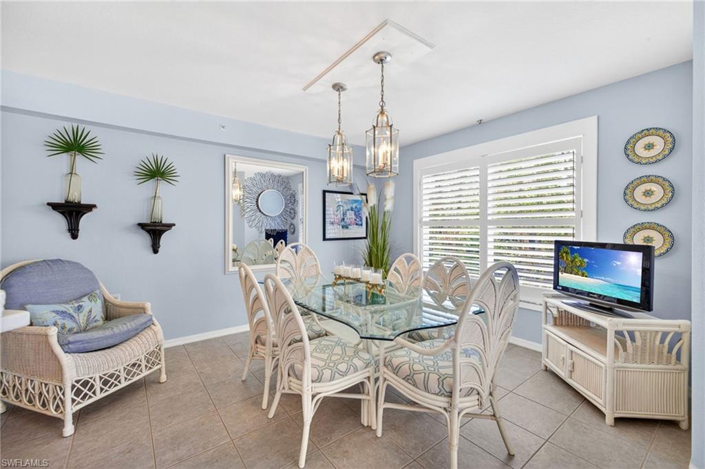 Dining area featuring light blue walls and neutral tile flooring