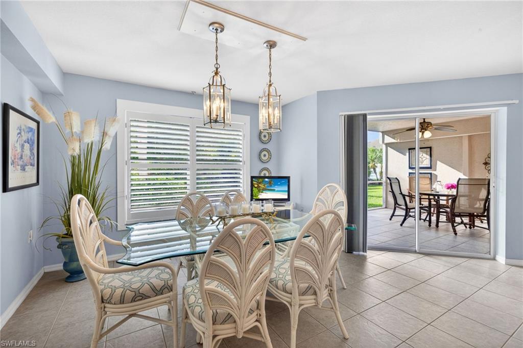 Dining area featuring light blue walls and neutral-toned tile flooring
