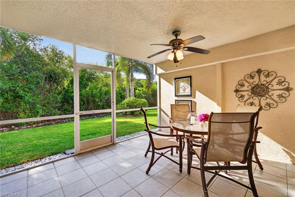 Screened patio with tile flooring and a ceiling fan