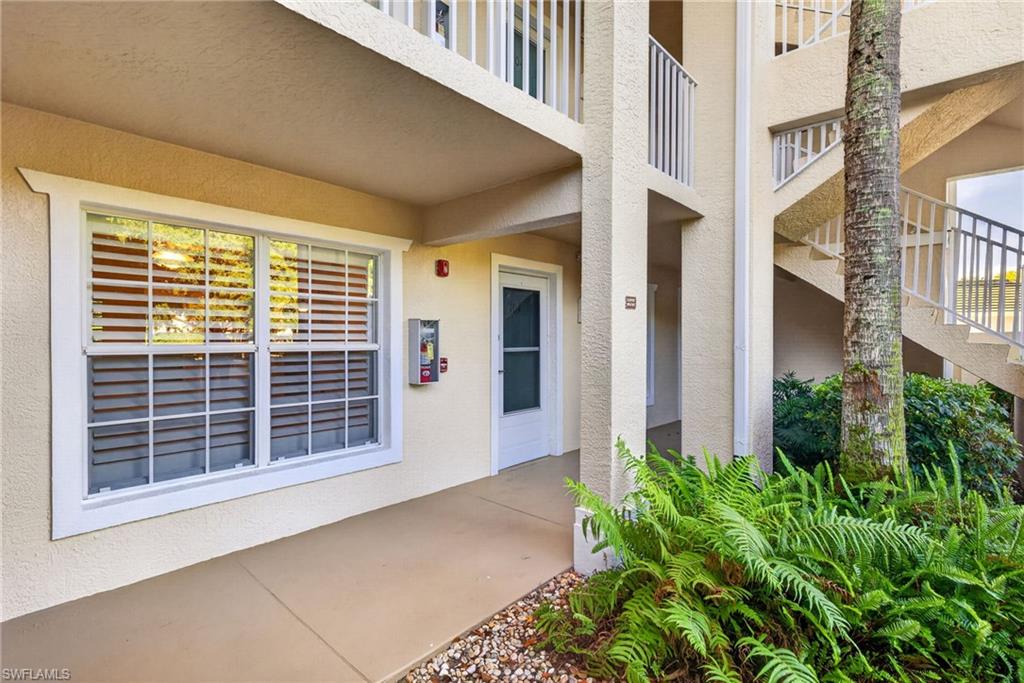 Ground-level unit with a private entrance, featuring a large window with white louvered blinds