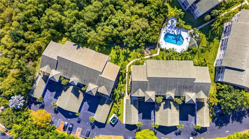 Aerial perspective showcasing multiple properties amidst lush green landscaping