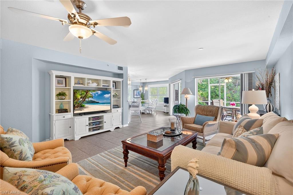 Spacious living area featuring tiled flooring and light blue wall tones