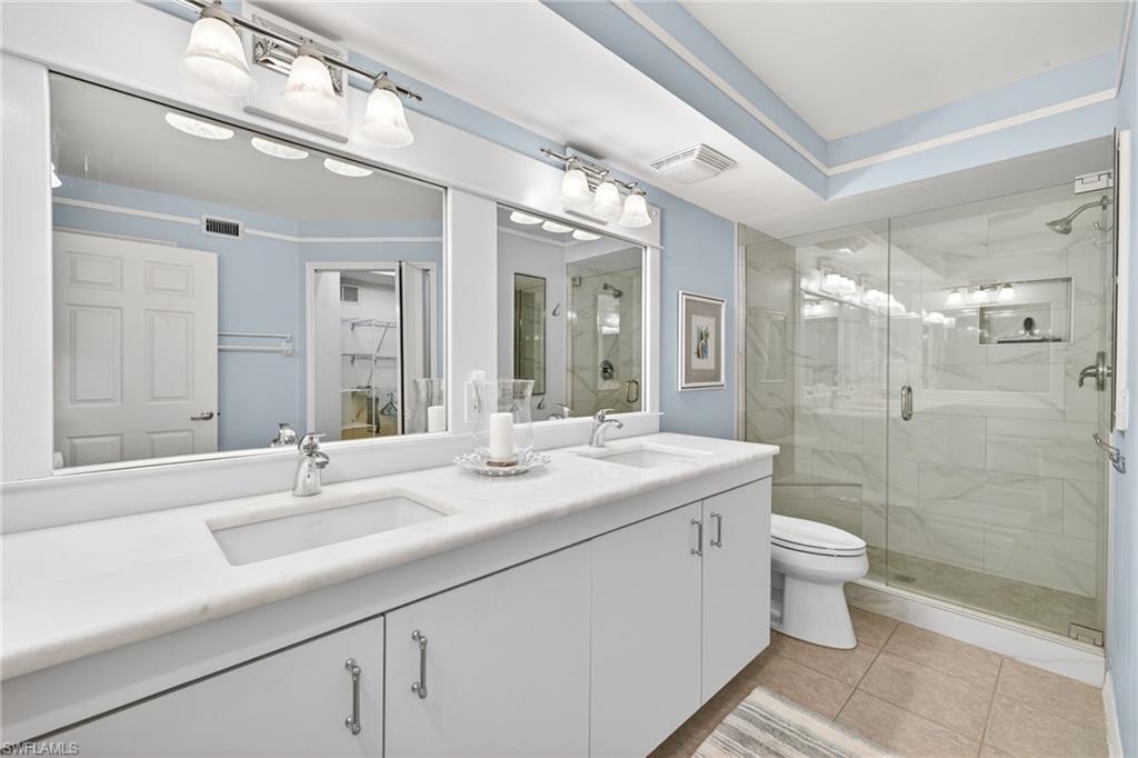 Primary Bathroom Dual vanity with undermount sinks and white countertops