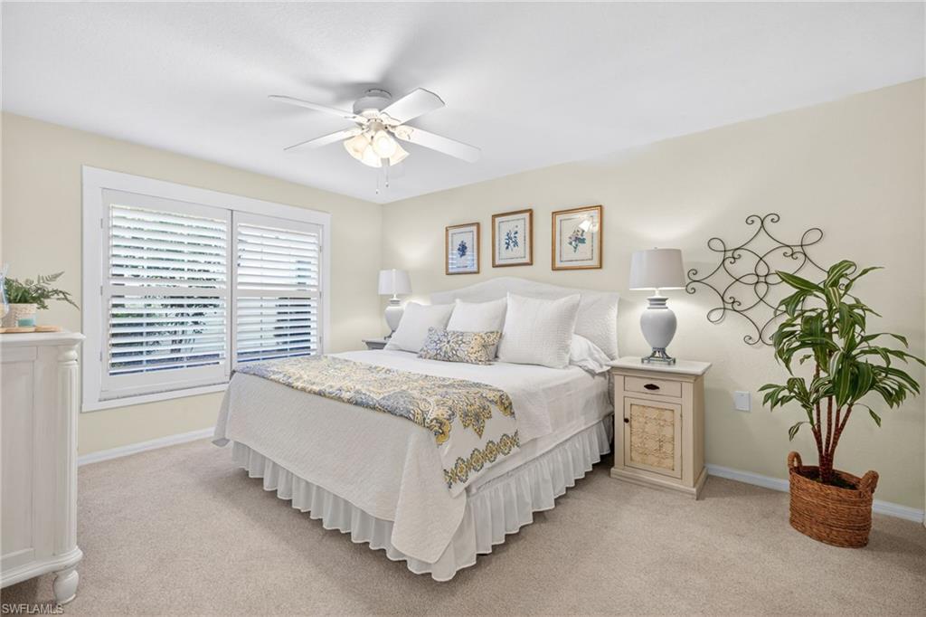 Primary Bedroom featuring carpet flooring, neutral-toned walls, and a ceiling fan with integrated lighting