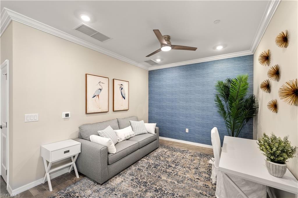 Living room featuring crown molding and ceiling fan