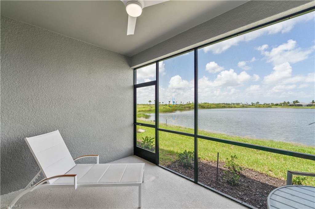 Unfurnished sunroom featuring a water view and ceiling fan