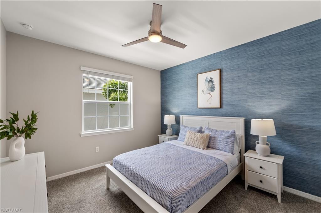 Bedroom with ceiling fan and carpet flooring
