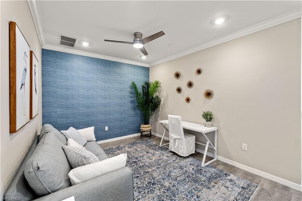 Office space featuring ceiling fan, hardwood / wood-style flooring, and ornamental molding