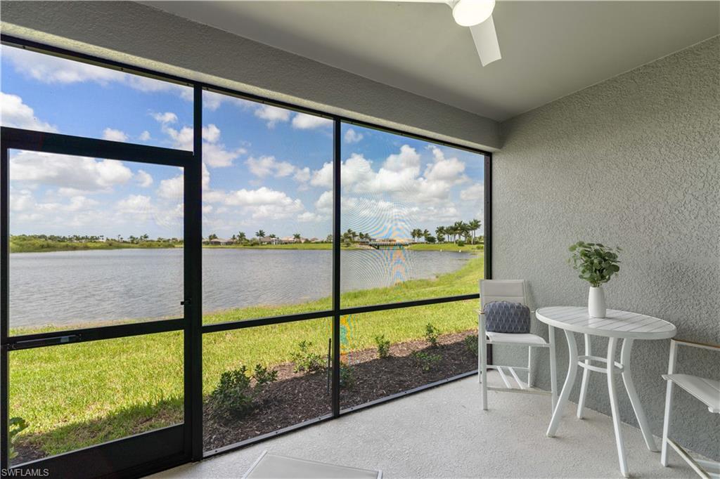 Sunroom / solarium with a water view and ceiling fan