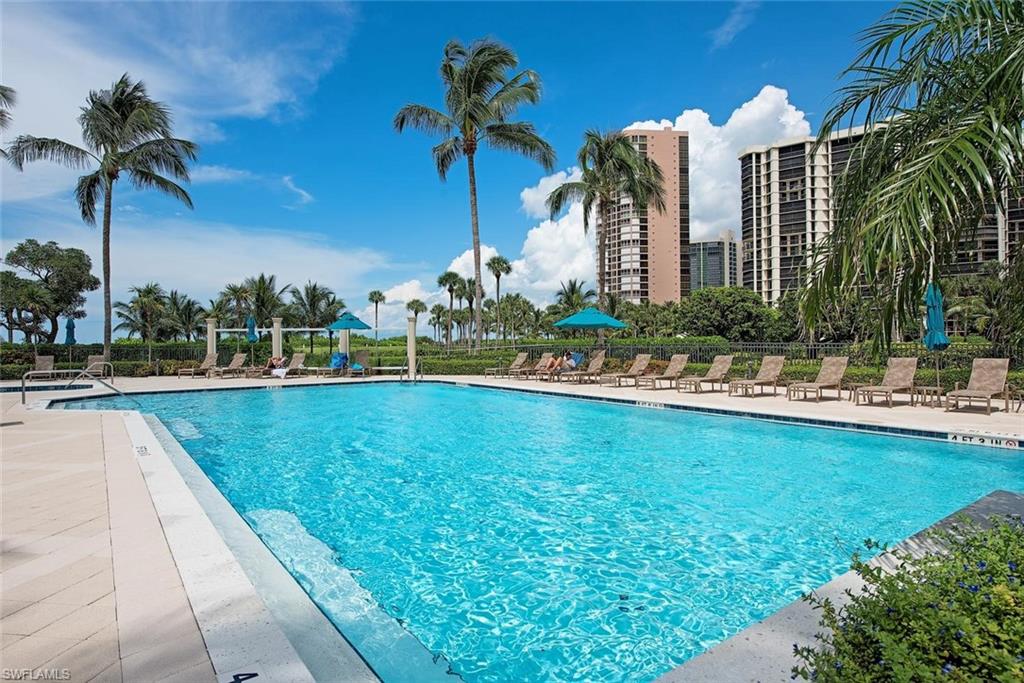 Outdoor swimming pool with integrated steps, surrounded by a light-toned paved deck