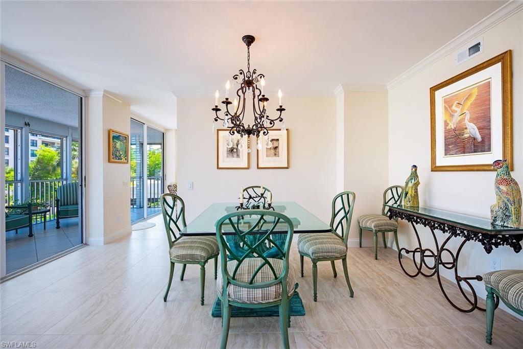 Light-toned tile flooring throughout an interior space featuring crown molding and recessed lighting