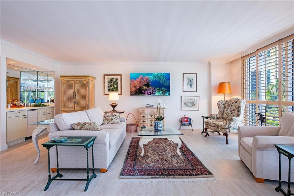 Spacious living area featuring light-toned tile flooring throughout