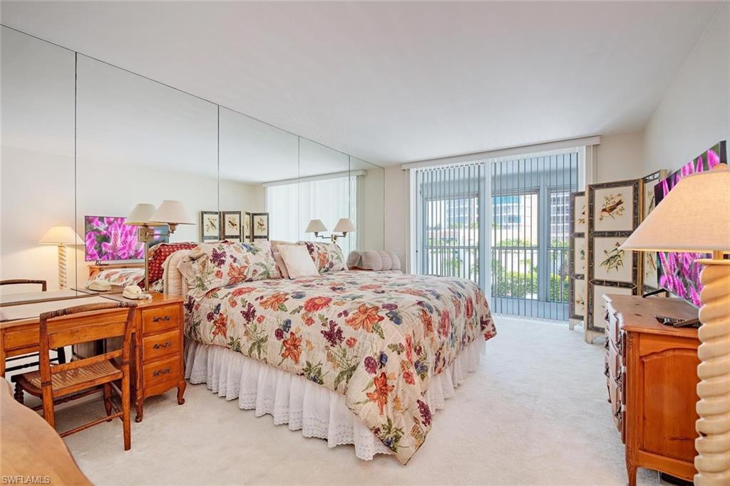 Wall-to-wall carpeting and full-length mirrored wall panels enhance the room's dimensions
