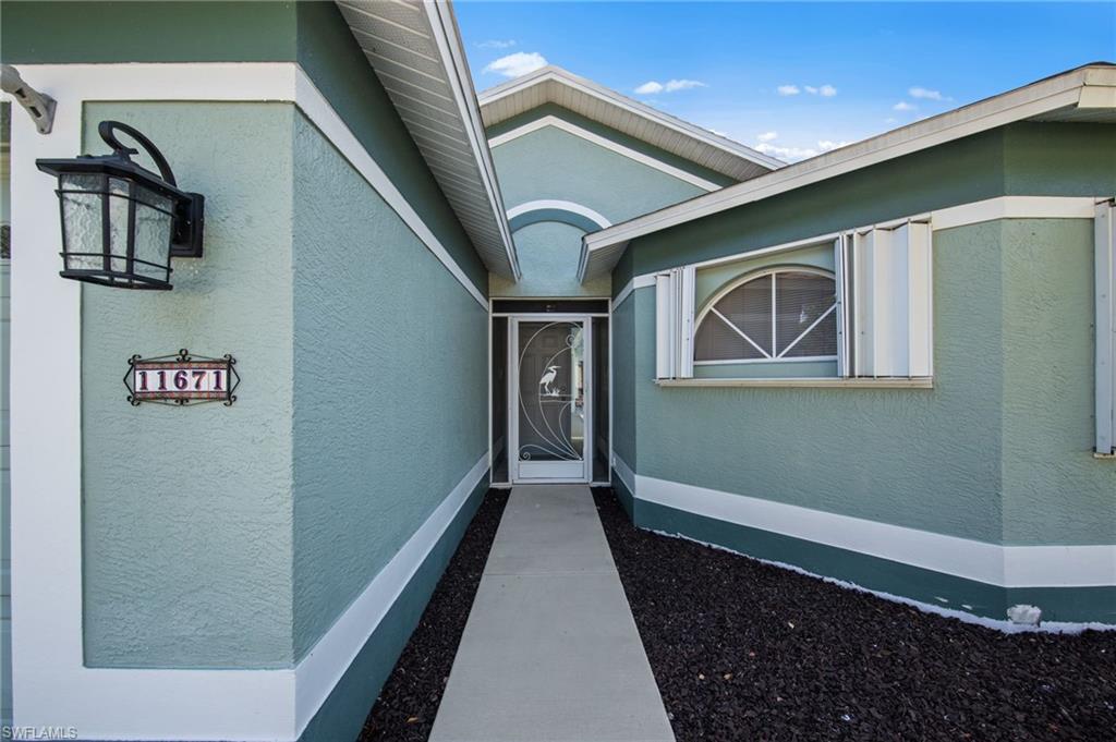 Stucco exterior with a textured finish and white trim