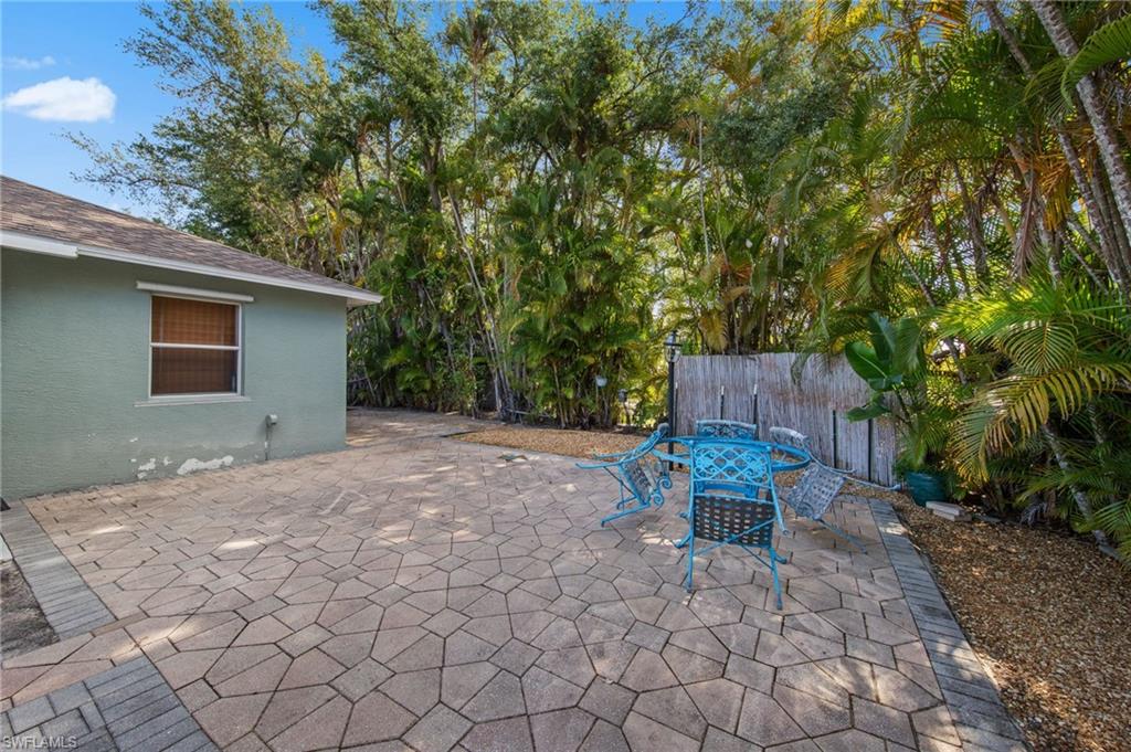Expansive paved patio featuring geometric stone pavers and a brick border
