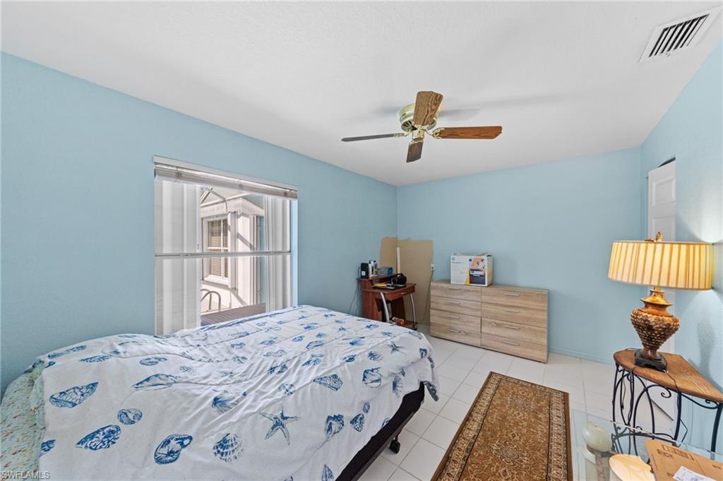 Bright room with white tile flooring and light blue walls