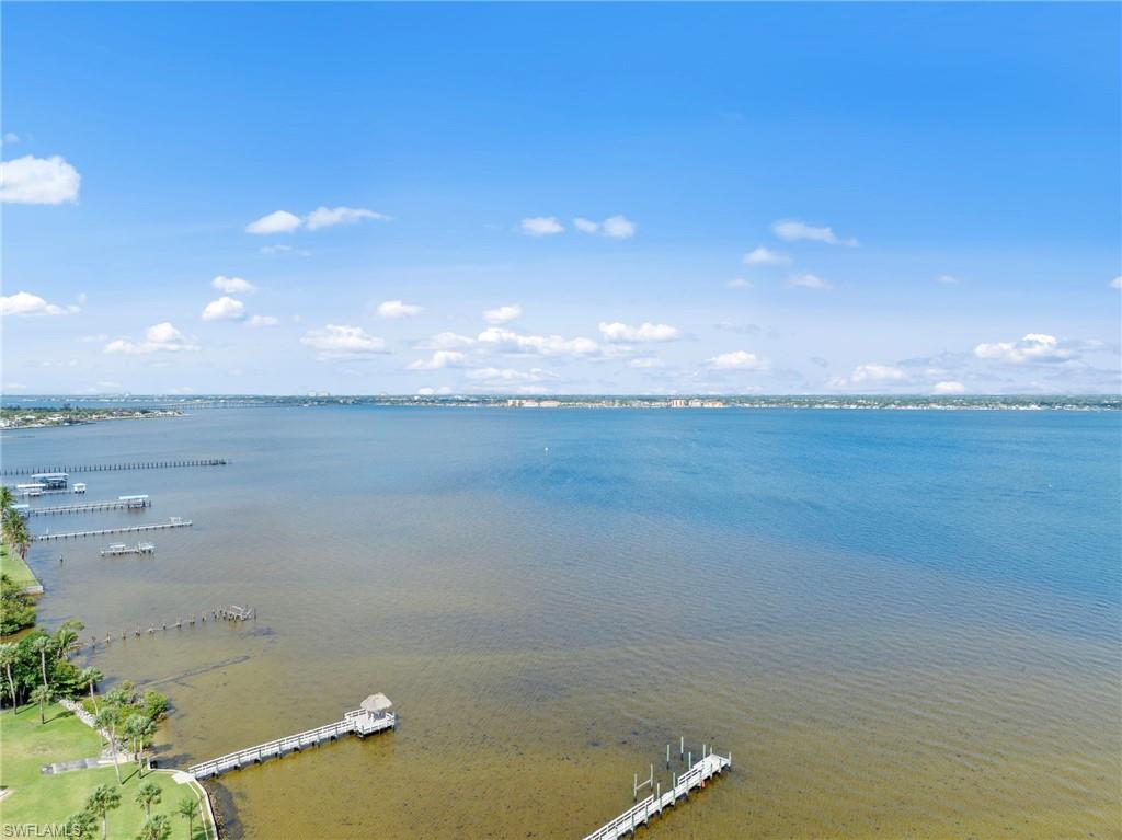 Expansive waterway frontage with multiple private docks and lush green landscaping